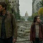 Joel and Ellie walk through an overgrown ruined city in The Last of Us